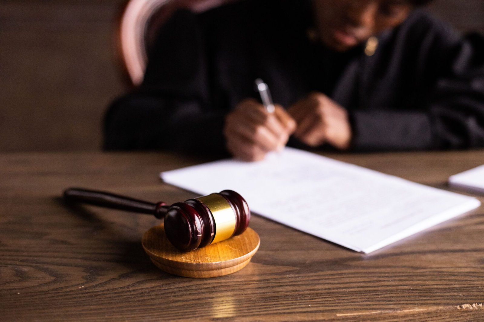 Judge signing legal documents at a desk representing California small claims court