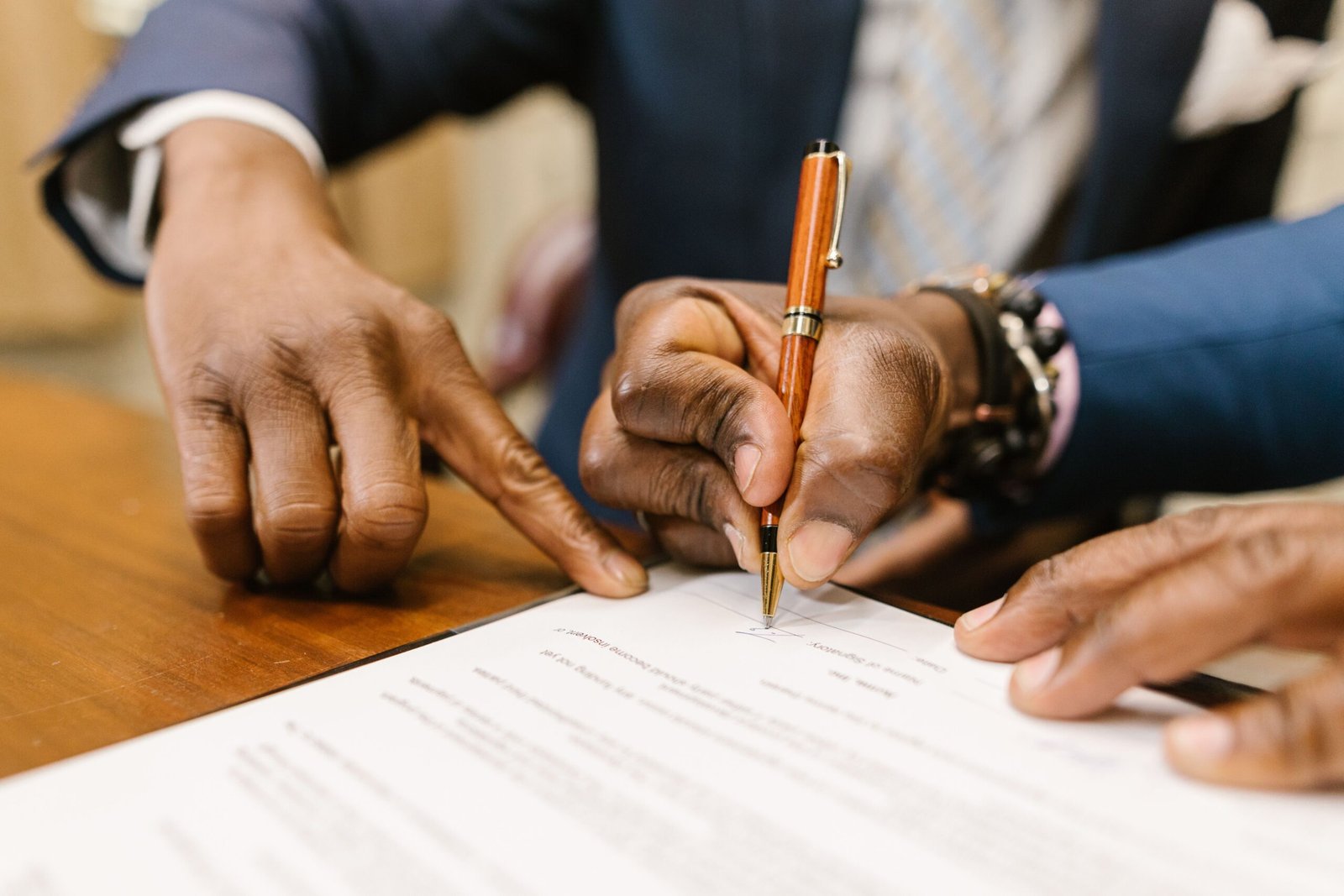 People reviewing and signing a legal document